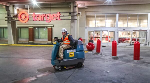 A worker helps to clean up after a Target in Buckhead that caught on fire in January.