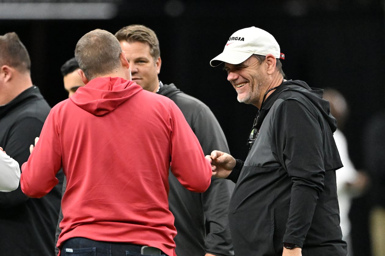 Bulldogs offensive coordinator Mike Bobo (right) — pictured during Sugar Bowl practice in December — and defensive coordinator Glenn Schumann received raises this offseason and will make $2.2 million for the 2026 season. (Hyosub Shin/AJC)