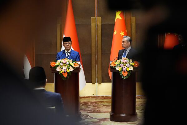 Indonesian Foreign Minister Sugiono, left, and Chinese Foreign Minister Wang Yi attend a press briefing after the first meeting of China-Indonesia joint foreign and defense ministerial dialogue at the Diaoyutai State Guest House in Beijing Monday, April 21, 2025. (Iori Sagisawa/Pool Photo via AP)