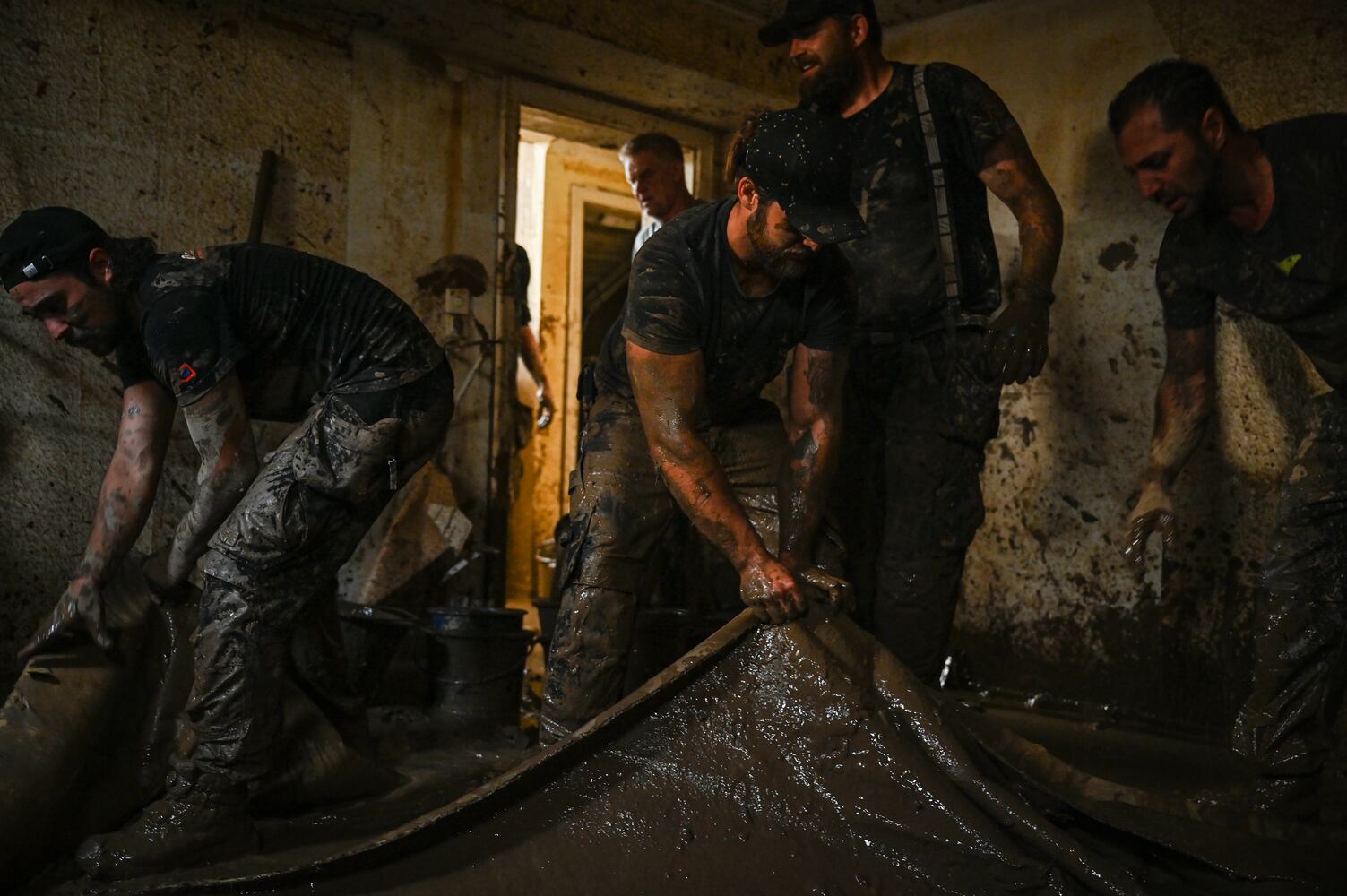 Volunteers help clean a house that was flooded last week by the Ahr River in Heimersheim, Germany, July 18, 2021. (Lena Mucha/The New York Times)