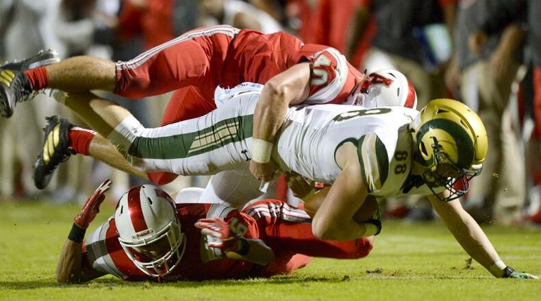 Archer defenders Andrew Spearman (6) and Kameron O'Rourke (40) make a tackle on Grayson tight end Beau DeBerry (88) in the first half of their game at Archer High School. Grayson won 34-31 in overtime and leads Region 8-AAAAAAA. PHOTO/Daniel Varnado