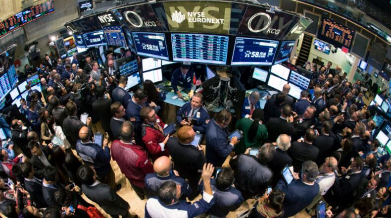 Traders and company executives of 58.com and Essent Group crowd the trading floor of the New York Stock Exchange during two IPO's, Thursday, Oct. 31, 2013. (AP Photo/Ben Hider, NYSE)