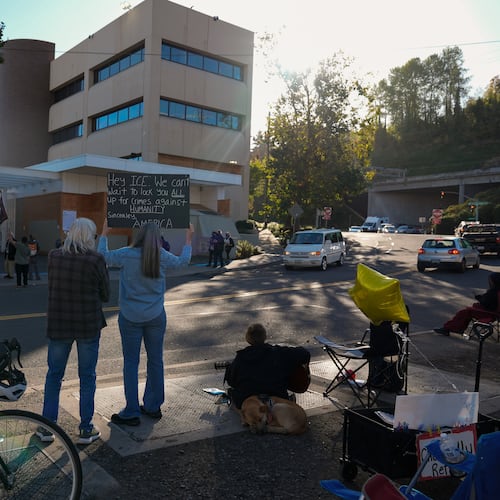 People protest outside a United States Immigration and Customs Enforcement (ICE) facility in Portland, Ore., Monday, Oct. 20, 2025. (AP Photo/Jenny Kane)