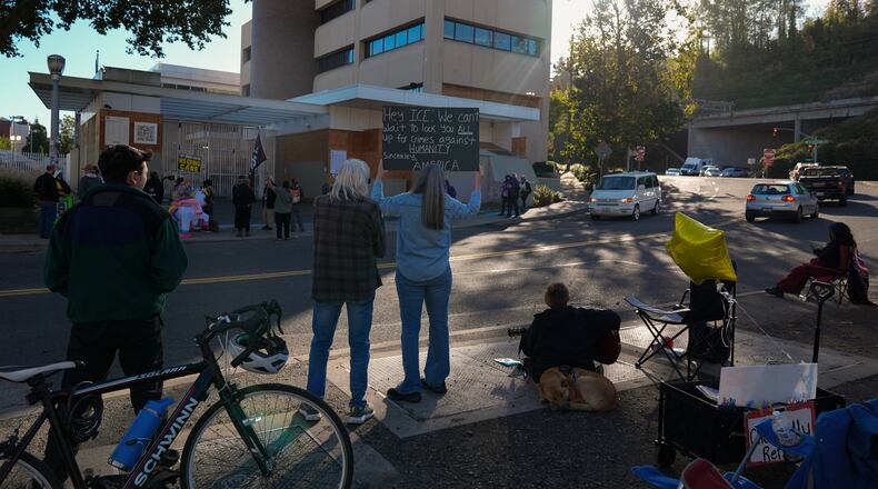People protest outside a United States Immigration and Customs Enforcement (ICE) facility in Portland, Ore., Monday, Oct. 20, 2025. (AP Photo/Jenny Kane)