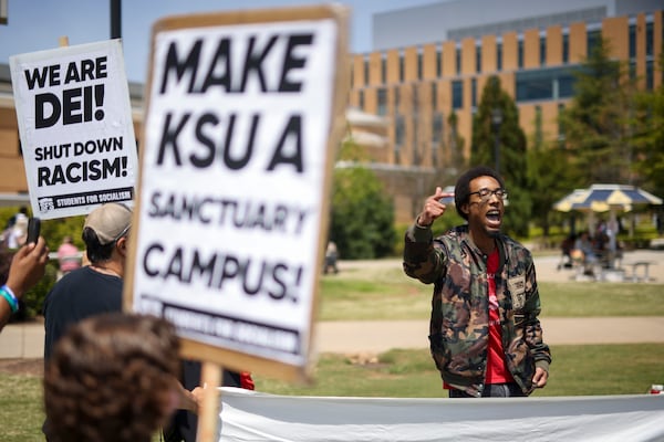 Around 20 protesters rallied against the Trump administration terminating the visa of a KSU student in April 2025. (Jason Getz/AJC)