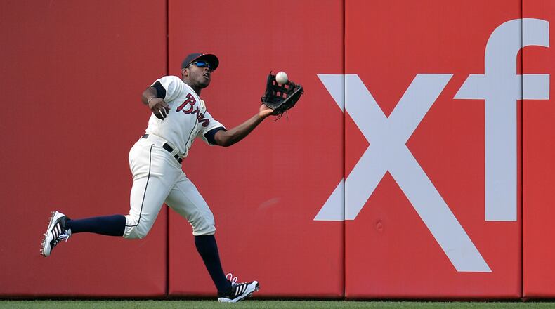 Atlanta Braves left fielder Justin Upton (8) catches a fly ball hit by San Francisco Giants third baseman Joaquin Arias (13) in the 3rd inning.
