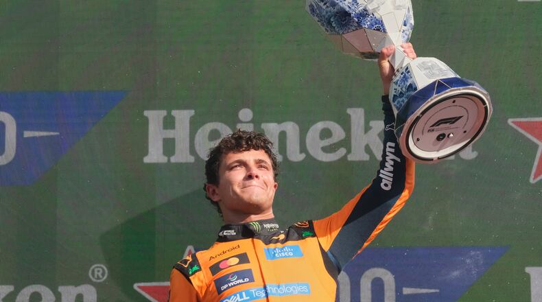 McLaren driver Lando Norris of Britain holds the trophy after winning the Formula One Dutch Grand Prix in Zandvoort , Netherlands, Sunday, Aug. 23, 2026. (AP Photo/Patrick Post)