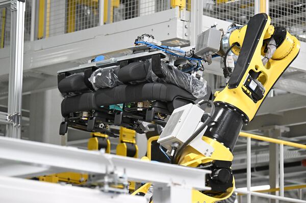 Oh, the robotic arm can install a car seat? Bet it can't pull off fourth finger vibrato on a violin. (Hyosub Shin/AJC)