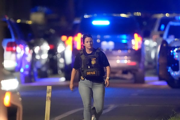 A Louisiana state police member works the scene on North Galvez Street as law enforcement pursue a fugitive that escaped from a New Orleans jail, Tuesday, May 20, 2025, in New Orleans. (AP Photo/Gerald Herbert)