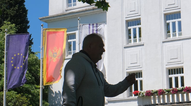 A man walks on a street in Montenegro's capital Podgorica, Monday, May 18, 2026. (AP Photo/Risto Bozovic)
