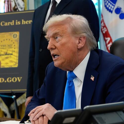 FILE - A poster showing the Trump Gold Card is seen as President Donald Trump signs executive orders in the Oval Office of the White House, Sept. 19, 2025, in Washington. (AP Photo/Alex Brandon, File)