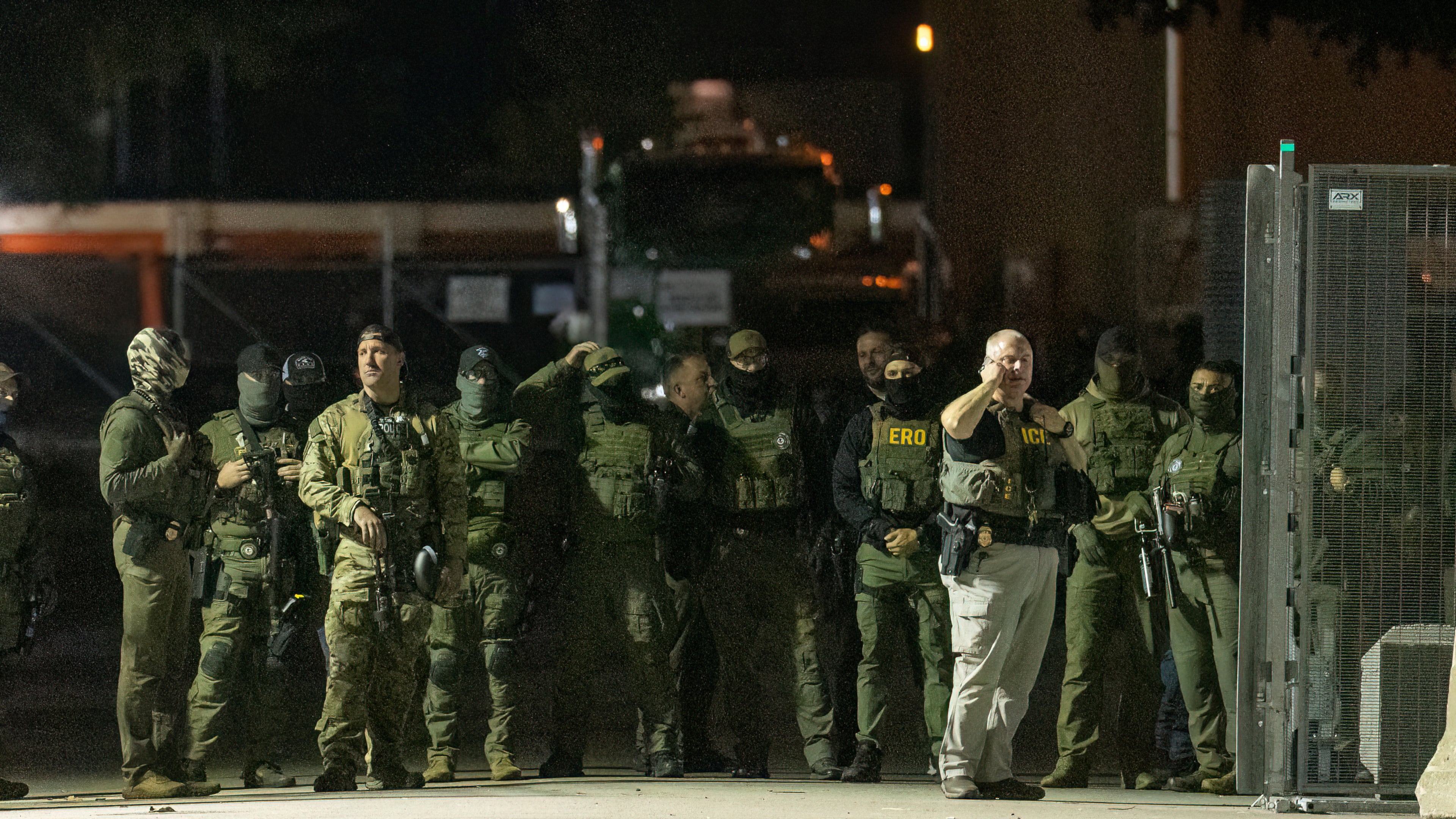 Federal law enforcement officers stand guard in the open gate of the fence built on Beach Street outside the Broadview ICE processing facility in suburban Broadview, Tuesday, Oct. 14, 2025. (Tyler Pasciak LaRiviere/Chicago Sun-Times via AP)