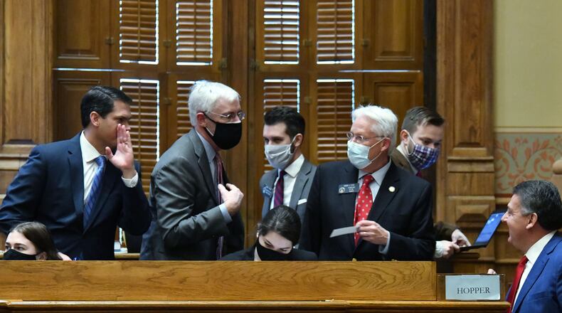 January 12, 2021 Atlanta - Lt. Gov. Geoff Duncan (left) confers with staff inside the Senate Chambers during the second day of the 2021 legislative session at the Georgia State Capitol building on Tuesday, January 12, 2021. (Hyosub Shin / Hyosub.Shin@ajc.com)