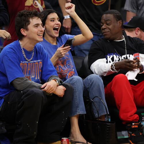 Timothée Chalamet, left, Kylie Jenner, center, and Tracy Morgan watch the second half of Game 4 in the Eastern Conference finals NBA basketball playoffs series between the New York Knicks and the Cleveland Cavaliers in Cleveland, Monday, May 25, 2026. (AP Photo/Tim Phillis)