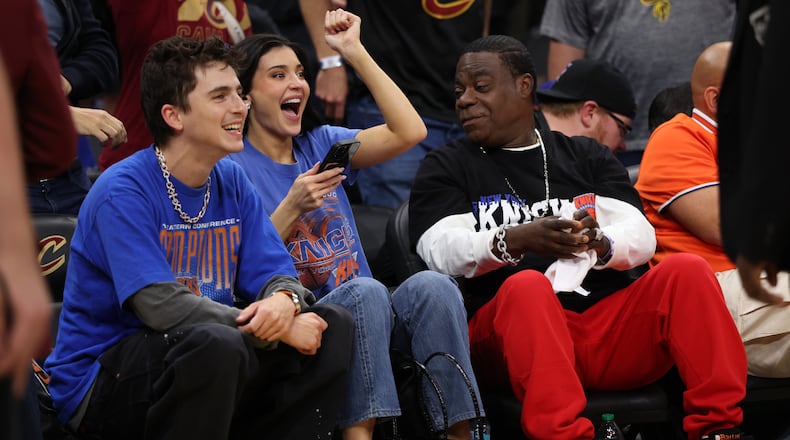 Timothée Chalamet, left, Kylie Jenner, center, and Tracy Morgan watch the second half of Game 4 in the Eastern Conference finals NBA basketball playoffs series between the New York Knicks and the Cleveland Cavaliers in Cleveland, Monday, May 25, 2026. (AP Photo/Tim Phillis)