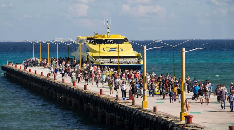 Tourists and passengers disembark from a ferry on to the wharf on Playa del Carmen, Mexico, Friday, March 2, 2018. Undetonated explosives were found on another ferry that runs between the Caribbean resorts of Playa del Carmen and the island of Cozumel, authorities said, less than two weeks after a blast shook another ferry plying the same route. (AP Photo/Gabriel Alcocer)