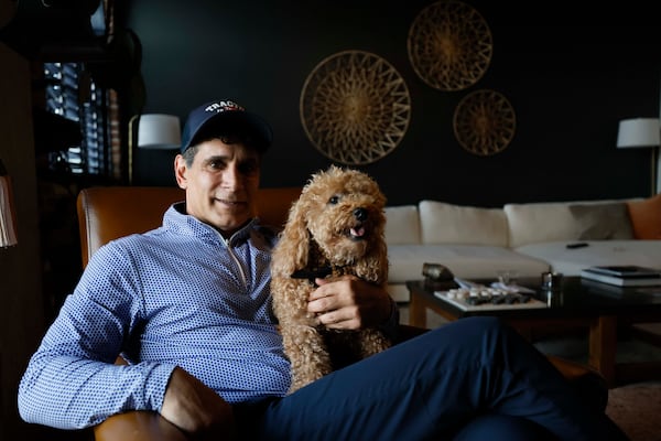 "He won't leave my side," Jared Mula says. Juju came home in March.
(Miguel Martinez/AJC)