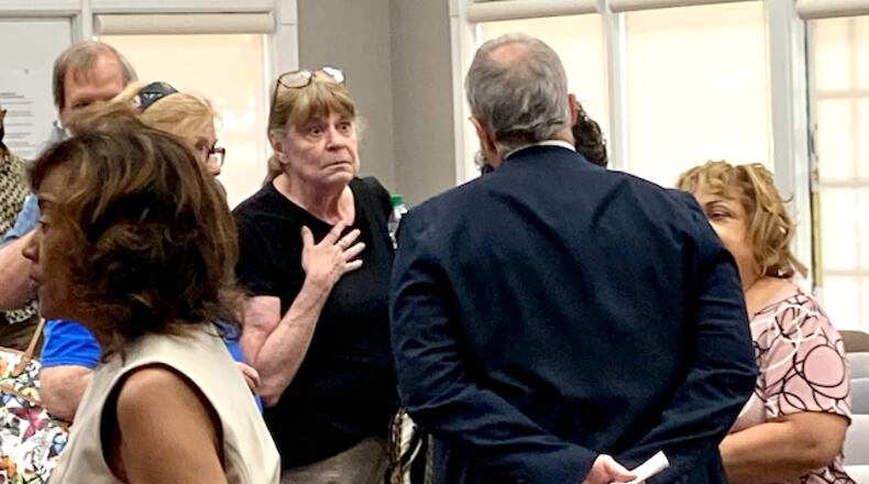 Attendees confronted Fayette County Commissioner Chuck Oddo after the board voted Thursday to hire a law firm to draft redistricting maps. Jill Howard Church for the AJC