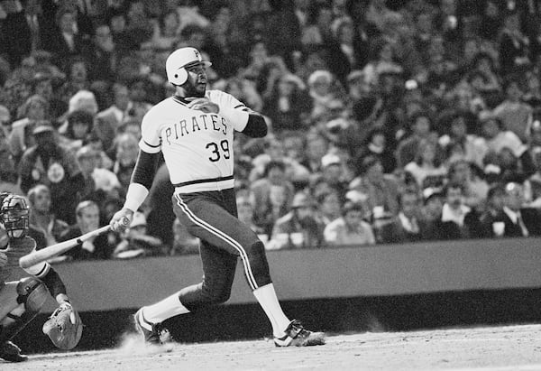 FILE - Pittsburgh Pirates Dave Parker smashes ball that took a bad hop in front of Orioles Rich Dauer and sailed into right field scoring Omar Moreno and the Bucs first run in the seventh inning in Game 6 in baseball's World Series game, Oct. 16, 1979, in Baltimore. (AP Photo/File)