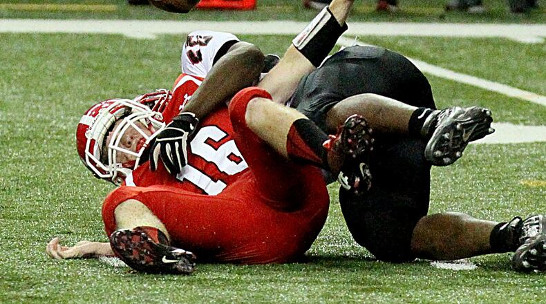 Marion County's (Buena Vista, GA) quarterback #16 Justin Eckert is sacked by Charlton County's (Folkston) #55 Teon Burroughs causing a fumble that Marion County recovered during their GHSA Class A-Public Football Championship game at the Georgia Dome in Atlanta on Saturday, December 14, 2013.