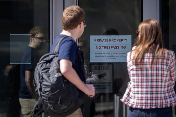 A no trespassing sign is posted on a door at the headquarters of the United States Institute of Peace, Tuesday, March 18, 2025, in Washington. (AP Photo/Mark Schiefelbein).