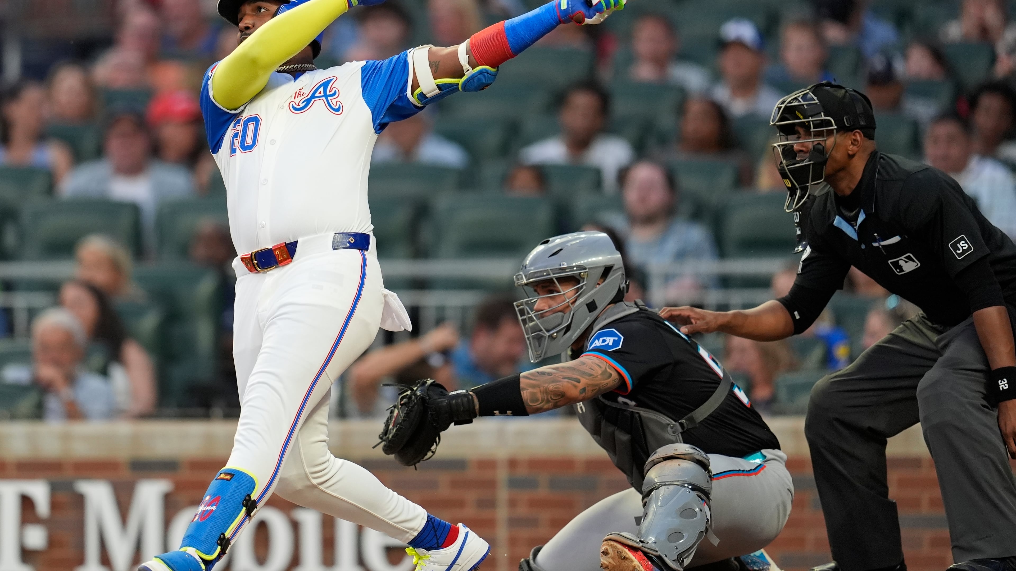 Atlanta Braves designated hitter Marcell Ozuna (20) hits a solo home run against the Miami Marlins in the fourth inning in the second baseball game of a doubleheader, Saturday, Aug. 9, 2025, in Atlanta. (AP Photo/Mike Stewart)