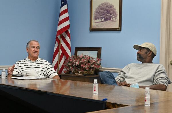Eugene Cason (left) and David Barron, both commissioners in Dooly County, speak in the Board of Commissioners chambers in Vienna on Wednesday, August 18, 2021. (Hyosub Shin / Hyosub.Shin@ajc.com)