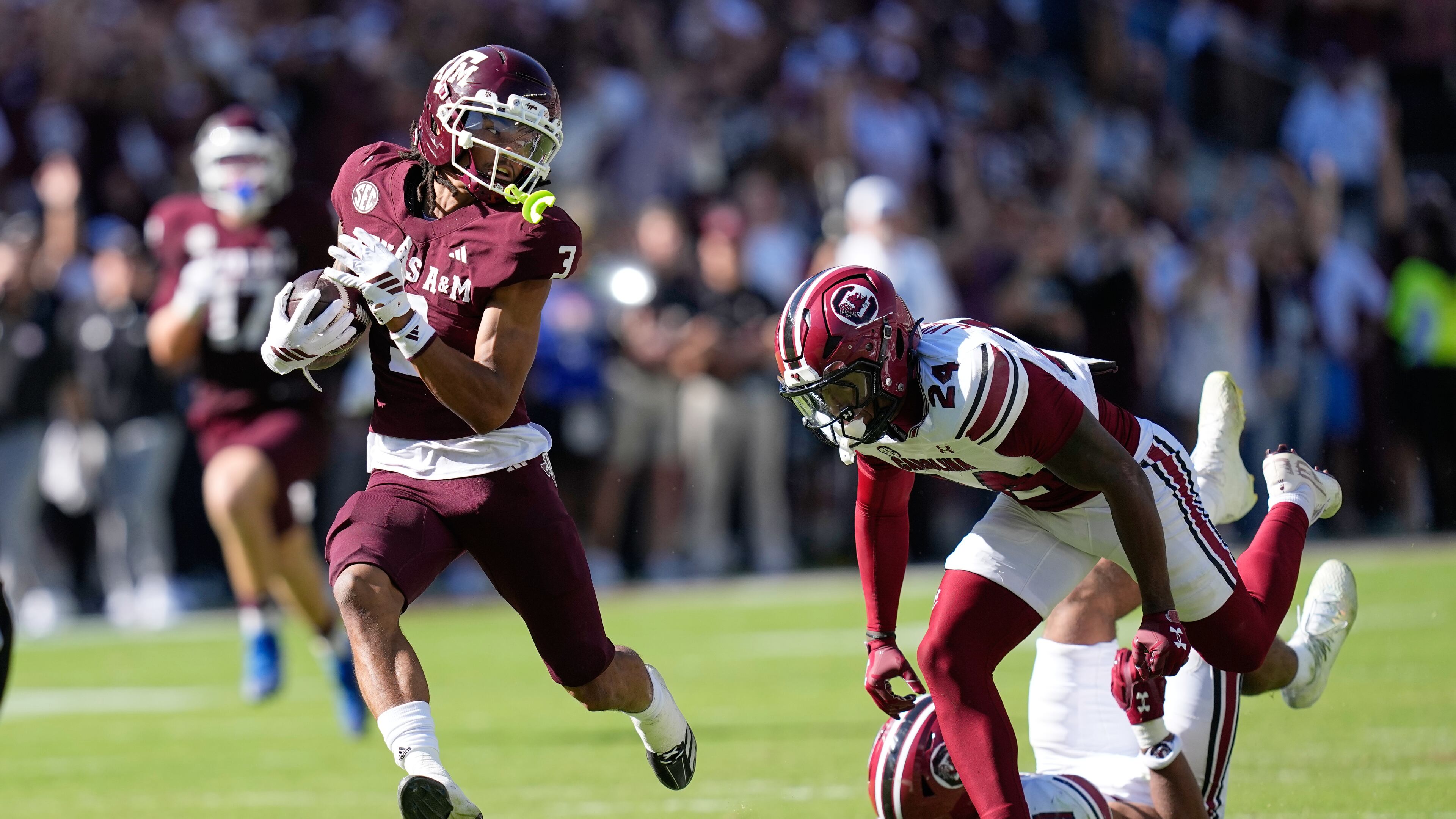 Texas A&M wide receiver Ashton Bethel-Roman (3) looks back at South Carolina defensive back Jalon Kilgore (24) after catching a pass for a first down during the second half of an NCAA college football game Saturday, Nov. 15, 2025, in College Station, Texas. (AP Photo/David J. Phillip)
