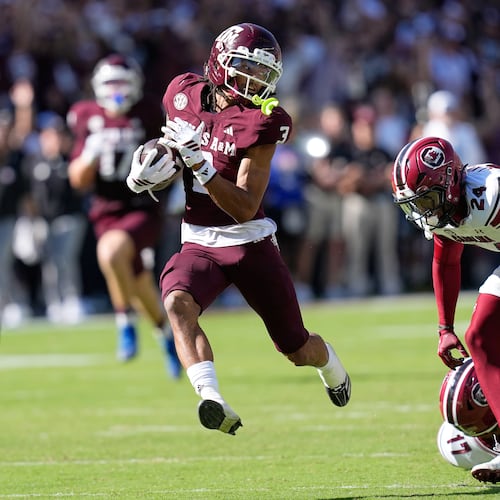 Texas A&M wide receiver Ashton Bethel-Roman (3) looks back at South Carolina defensive back Jalon Kilgore (24) after catching a pass for a first down during the second half of an NCAA college football game Saturday, Nov. 15, 2025, in College Station, Texas. (AP Photo/David J. Phillip)