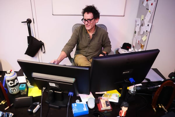 Variety Playhouse Assistant General Manager Derek Southern, a 22-year staffer at the Little Five Points concert hall, works at his desk. (Abbey Cutrer/AJC)