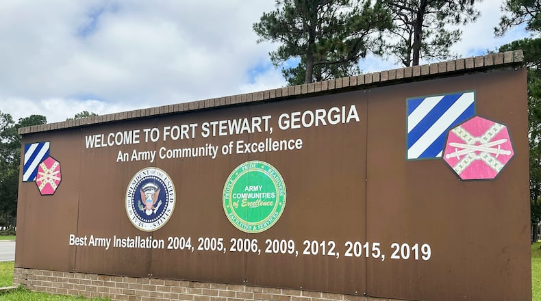 FILE - A sign stands outside the main gate of Fort Stewart, Ga., Aug. 6, 2025. (AP Photo/Russ Bynum, File)