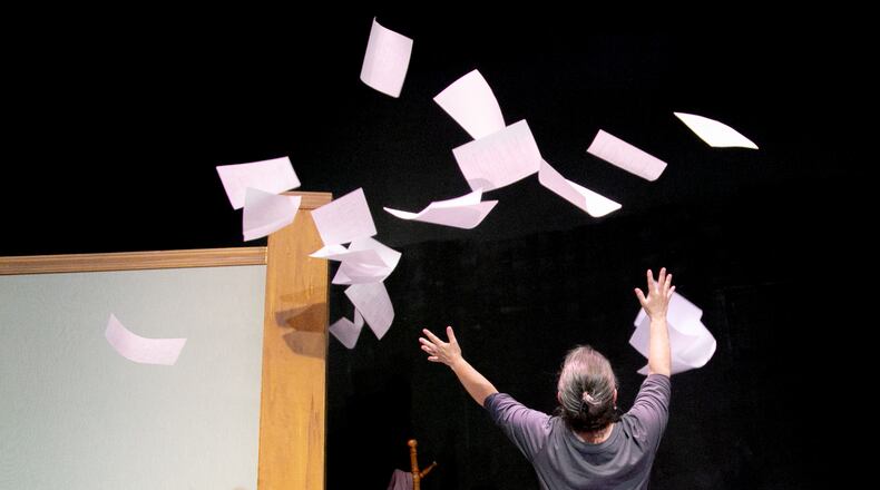Susan (Laurie Beasley) tosses papers in the air in Matt Hoffman’s "The Manuscript" at the 2023 Essential Theatre Play Festival. Courtesy of Casey Gardner Ford