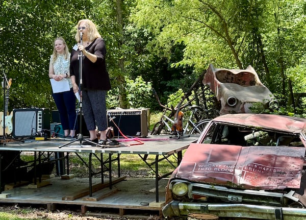 Tina Cox, executive director of Paradise Garden Foundation (right), and architect Sarah Pitts on stage during the grand opening celebration for The World Folk Art Church on June 21, 2025. 
Danielle Charbonneau/AJC