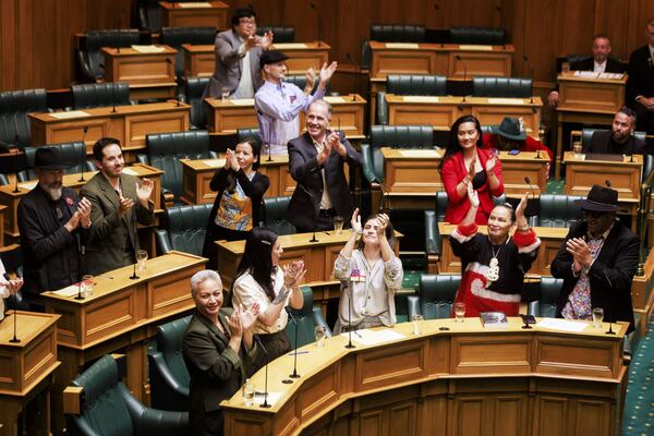 Members of Parliament celebrate as the Principles of the Treaty of Waitangi bill was rejected by Parliament in a 112 to 11 vote in Wellington, New Zealand, Thursday, April 10, 2025. (Robert Kitchin/Stuff via AP)
