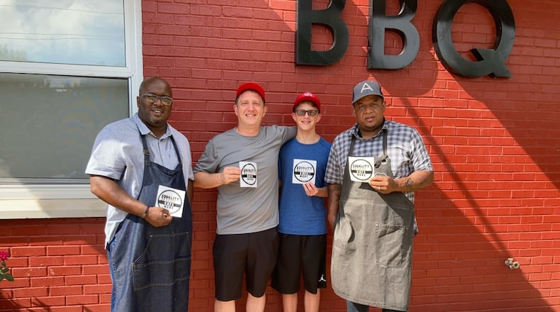 Equality Lives Here founder and NFA Burger Billy Kramer (second from left) with Lake & Oak BBQ owners Josh Lee (far left) and Todd Richards (far right). / Courtesy of Equality Lives Here