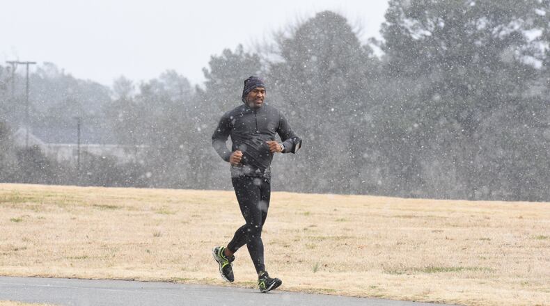 Flurries on Tues., Feb. 9, 2016, did not stop people from hitting walking and running trails in Snellville in Gwinnett County. HYOSUB SHIN / HSHIN@AJC.COM