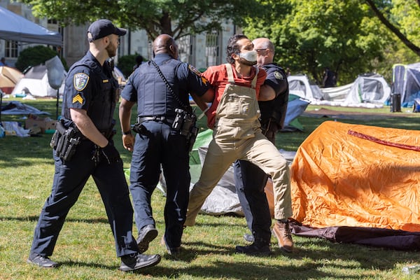 Police arrest one of about two dozen pro-Palestinian protesters who set up an encampment at the Emory campus in Atlanta on Thursday, April 25, 2024. (Arvin Temkar/AJC)