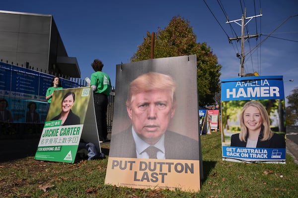 A campaign corflute depicting the Leader of the Opposition Peter Dutton as U.S. President Donald Trump outside a polling booth in Melbourne, Australia, Saturday, Australia, May 3, 2025. (Joel Carrett/AAP Image via AP)