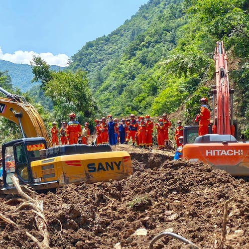 In this photo released by Xinhua News Agency, rescuers conduct search and rescue at the site of a landslide at a village in Nanhe township of Tanchang County, Longnan City, northwest China's Gansu Province on Tuesday, July 7, 2026. (Xinhua via AP)