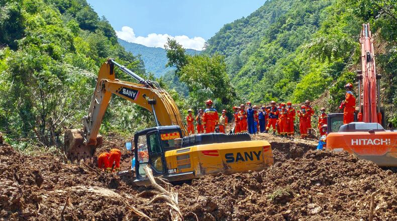 In this photo released by Xinhua News Agency, rescuers conduct search and rescue at the site of a landslide at a village in Nanhe township of Tanchang County, Longnan City, northwest China's Gansu Province on Tuesday, July 7, 2026. (Xinhua via AP)