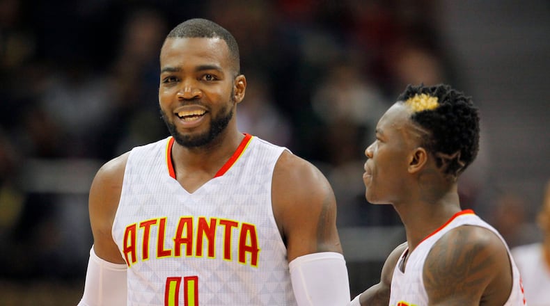 Atlanta Hawks forward Paul Millsap (4) and guard Dennis Schroder (17) reacts after Milsap scored late in the second half of an NBA basketball game between the Detroit Pistons and Atlanta Hawks on Friday, Dec. 30, 2016, in Atlanta. The Hawks won the game 105-98. (AP Photo/Todd Kirkland)