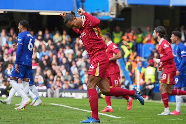Liverpool's Virgil van Dijk celebrates scoring his side's first goal during the English Premier League soccer match between Chelsea and Liverpool at Stamford Bridge stadium in London, Sunday, May 4, 2025. (AP Photo/Kin Cheung)