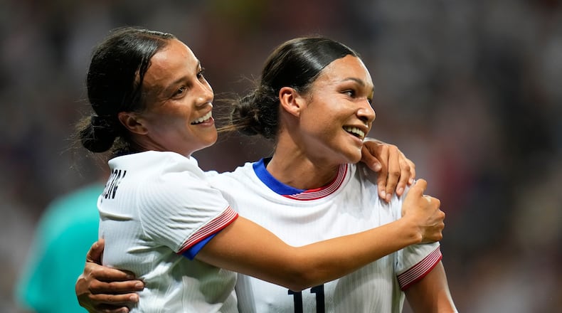 FILE - United States' Mallory Swanson, left, reacts with teammate Sophia Smith after scoring her side's third goal during a women's group B match between the United States and Zambia at Nice Stadium at the 2024 Summer Olympics, July 25, 2024, in Nice, France. (AP Photo/Julio Cortez, File)