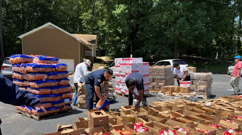 Volunteers help sort food from the Atlanta Food Bank into boxes for Gwinnett's Mobile Food Distribution program. (Courtesy Gwinnett County)