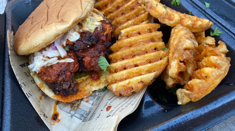 Menu items from Khana-Americana showcase creative playfulness, as common Indian flavors are woven into everyday American bites, such as with the tandoori fried chicken sandwich. Ligaya Figueras/ligaya.figueras@ajc.com