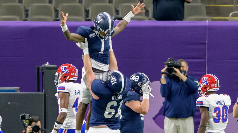 Georgia Southern quarterback Shai Werts (1) is lifted up after scoring a touchdown against Louisiana Tech during the first half of the New Orleans Bowl Wednesday, Dec. 23, 2020, in New Orleans. (Matthew Hinton/AP)