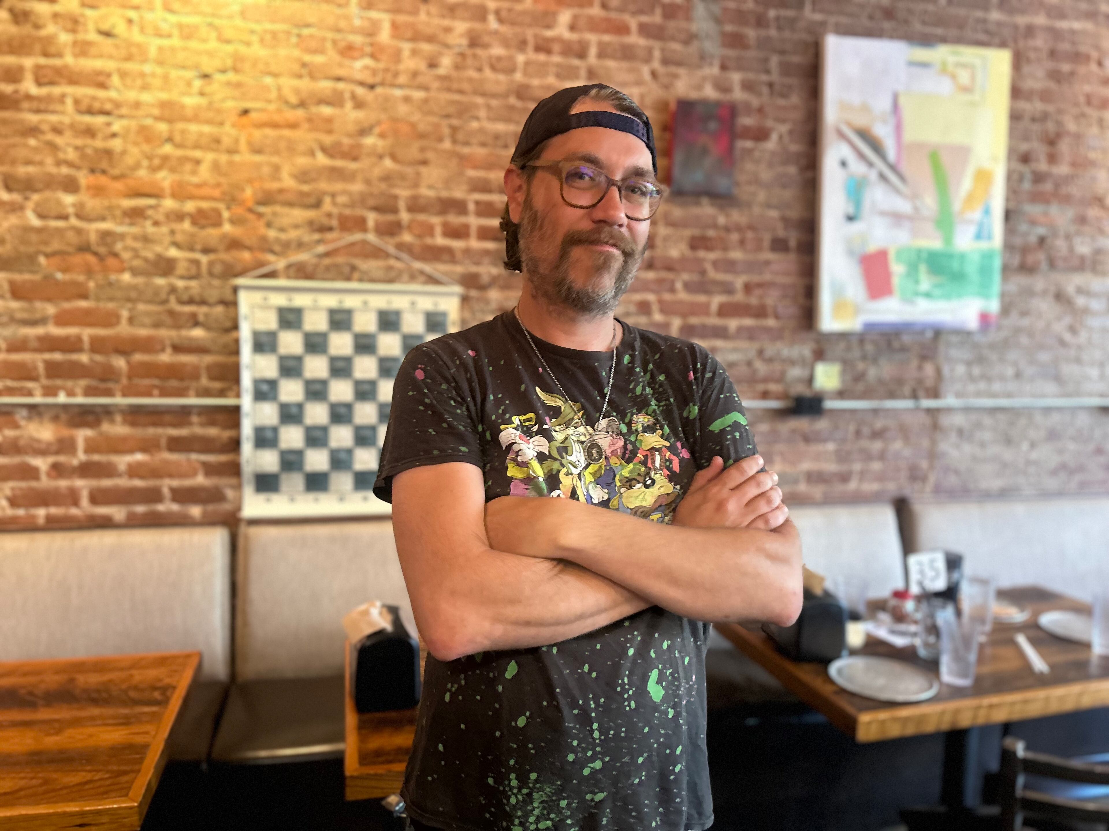 Justin Cammer, a front-of-house employee, is seen pictured inside Mojo Pizza N' Pub on Thursday, June 19, 2025. (Gray Mollenkamp/AJC)