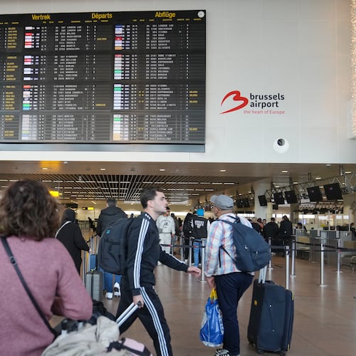 A passenger looks at a departures board after several cancellations and delays due to reported overnight drone activity over Brussels International Airport in Zaventem, Wednesday, Nov. 5, 2025. (AP Photo/Virginia Mayo)