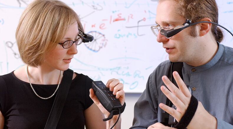 Thad Starner, who is now on the faculty at Georgia Tech, and a former student are shown with an earlier version of a wearable computer. CONTRIBUTED