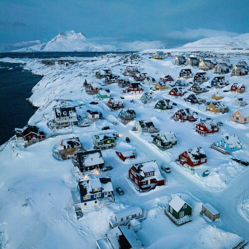 FILE - Houses covered in snow are seen on the coast of a sea inlet of Nuuk, Greenland, Friday, March 7, 2025. (AP Photo/Evgeniy Maloletka, File)